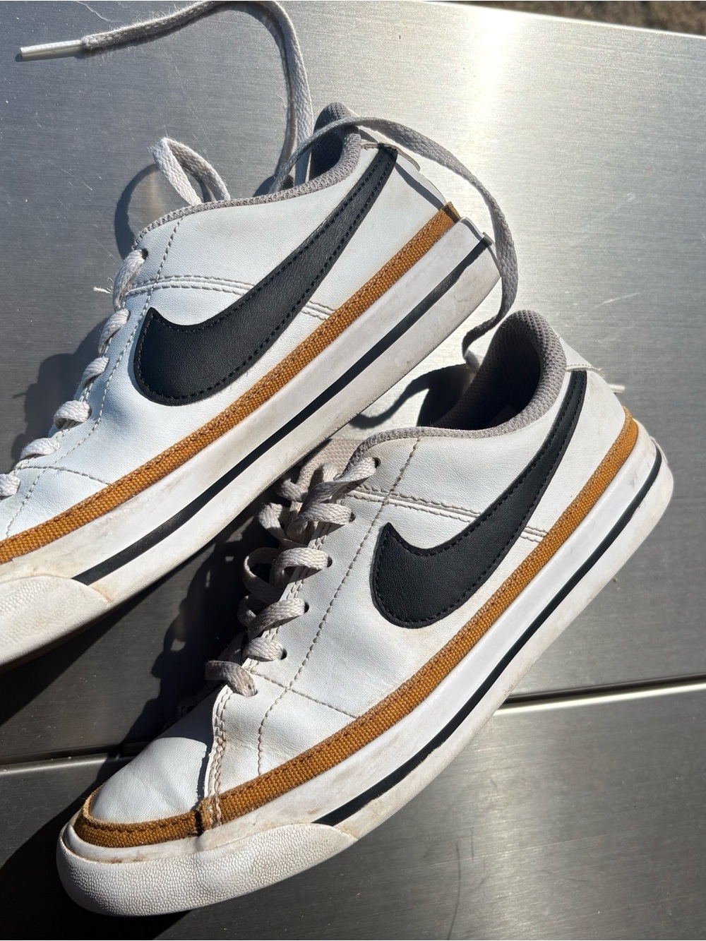 Nike Kids White Sneakers with Black Swoosh and Tan Stripe
